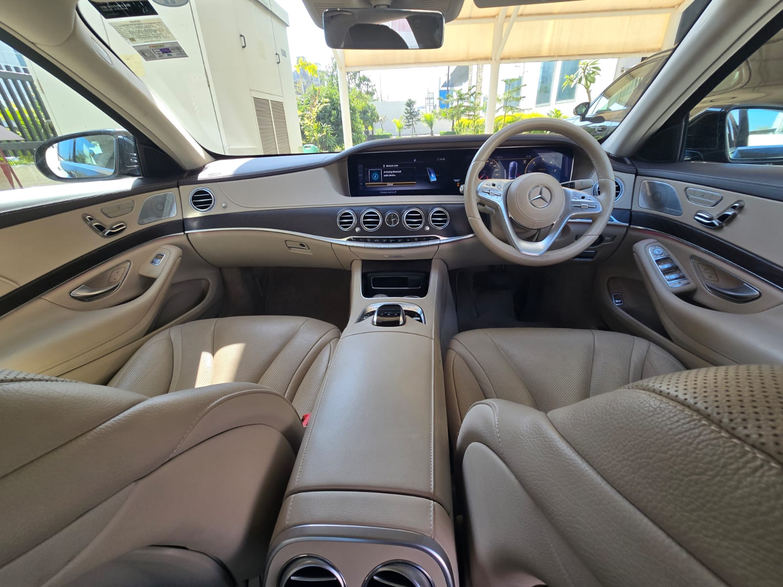 Full dashboard view with cream leather interior from rear seats